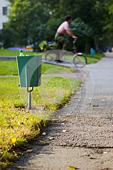 City garbage bin and cyclist
