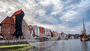 City Gdansk with the oldest medival port crane called Zuraw and a promenade along the riverbank of Motlawa River.