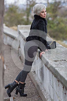 City girl resting at public park in overcast autumn day