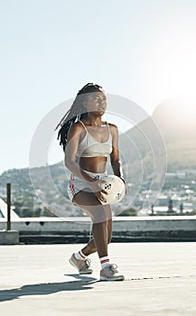 City, girl and soccer on rooftop for sports fitness training with concentration in South Africa. Exercise, football and