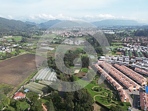 a city and a golf course with mountains in the background