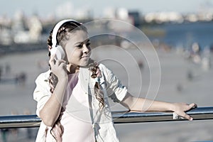 City guide and audio tour. Girl little tourist kid explore city using audio guide application. Free style of travelling