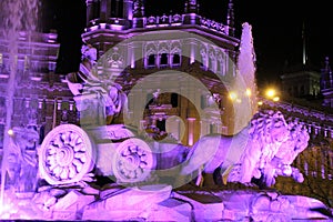 City Hall building and Cibeles fountain illuminated in purple for Women's Day