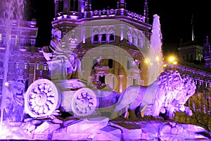 City Hall building and Cibeles fountain illuminated in purple for Women's Day