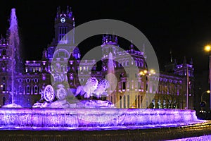 City Hall building and Cibeles fountain illuminated in purple for Women's Day