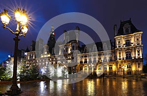 The city hall of Paris decorated with Christmas trees at night. Paris, France.