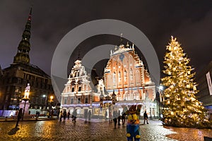 City Hall Square with House of the Blackheads and Saint Peter church in Old Town of Riga at night during Christmas, Latvia