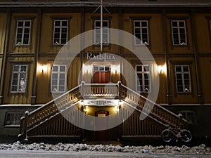 City hall of Tromso, north Norway at night in december - even the bicycle covered in snow