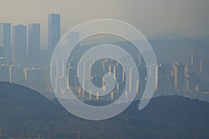 City high-rises and buildings in the early morning fog in the distance