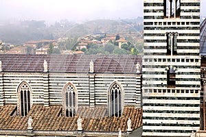 City with historical buildings and roofs of the 14th century Duomo di Siena, Italy. UNESCO Heritage Site