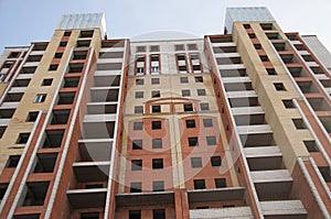 City house under construction. Unfinished multi-storey building. Uncovered facade of the building. Concrete construction is the
