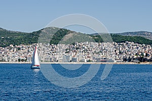 City of Kavala Greece viewed from ferry.Small sailboat