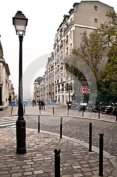 A city lamp in the corner of the street in Monmarte