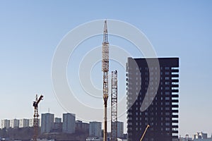 City landscape with construction cranes and skyscraper