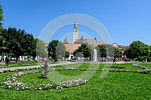 City landscape with Ferdinand I King Square Piata Regele Ferdinand I and green park in the old city center of Medias, in