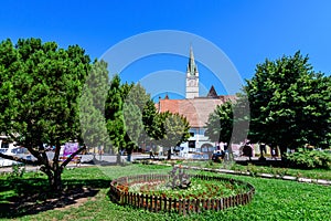 City landscape with Ferdinand I King Square Piata Regele Ferdinand I and green park in the old city center of Medias, in