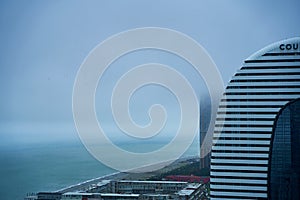 City landscape. Modern architecture of Batumi. A popular resort on the Black Sea coast in Georgia. Cloudy rainy day