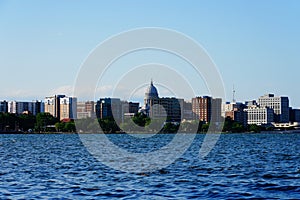 City landscape photo of Madison, Wisconsin capitol and city buildings from Olin park