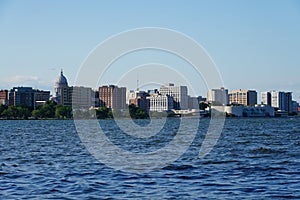 City landscape photo of Madison, Wisconsin capitol and city buildings from Olin park