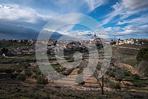 City landscape of the town under a blue sky with a olive field in the foreground, Colmenar de Oreja, Spain photo