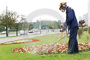 City landscaper cutting grass