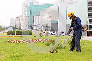 City landscaper mowing lawn