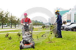 City landscapers gardeners mowing lawn