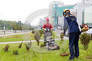 City landscapers gardeners mowing lawn