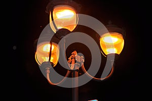 City lantern with three light bulb in the night