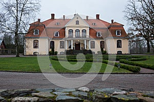 City Liepupe, Latvia. Old yellow manor with garden.Travel photo