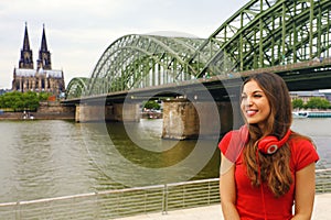 City life girl with headphone and red t-shirt enjoy her spare time in Cologne, Germany