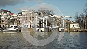 City life. Historic canal houses, bridge and traffic in Amsterdam