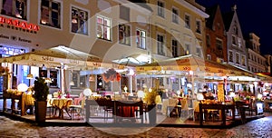 City night life  street cafe tables people dinner pink light on table Lifestyle Travel Restaurant City Light Old Town Tallinn ,