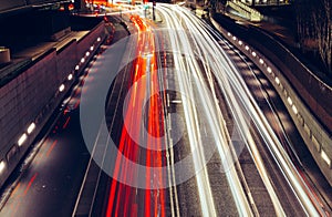 City light trails of fast moving traffic on road in London at ni