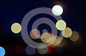 City lights abstract circular bokeh on a blue background.