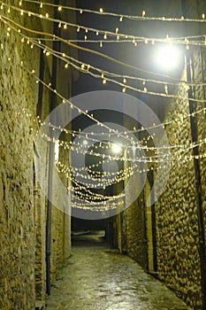 CITY LIGHTS ACROSS BUILDINGS IN THE OLD TOWN AT NIGHT