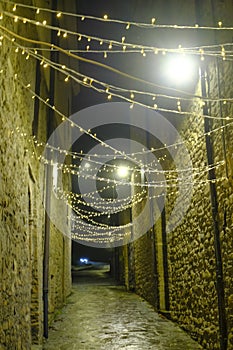 CITY LIGHTS ACROSS BUILDINGS IN THE OLD TOWN AT NIGHT