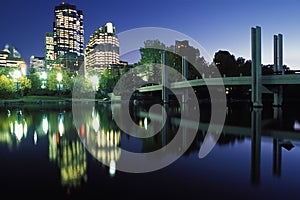 City lights reflect in river