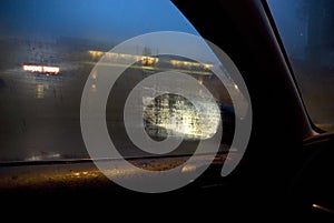 City lights seen through steamy car window