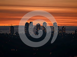 City lights after sunset on darker sky and cumulus clouds background