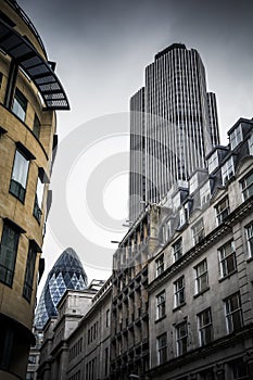 City of London buildings with two skyscrapers under moody sky