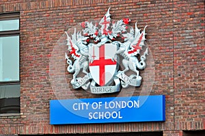 City of London school emblem on wall in London, UK