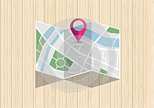 City map with mark pin folding on wooden desk