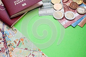 City map Two Russian foreign passports and euro notes of various denominations and eurocents on a green background