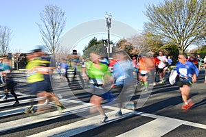 City marathon with runners in motion blur