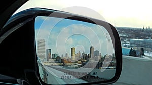 City Of Milwaukee In The Rear-view Mirror Of Car