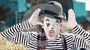 City, mime and face of man with tongue out for funny joke, humor and crazy facial expression. Theatre, street performer