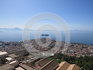 The city of Naples from above. Napoli. Italy. Vesuvius volcano behind.Orthodox church cross and the moon.