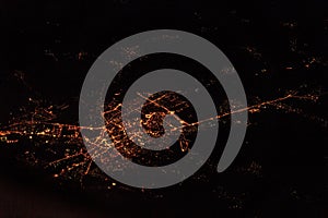 City at night through airplane window