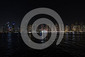 City at night, panoramic scene of downtown reflected Dubai